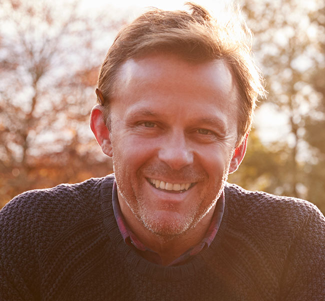 Portrait Of Mature Man Repairing Garden Fence